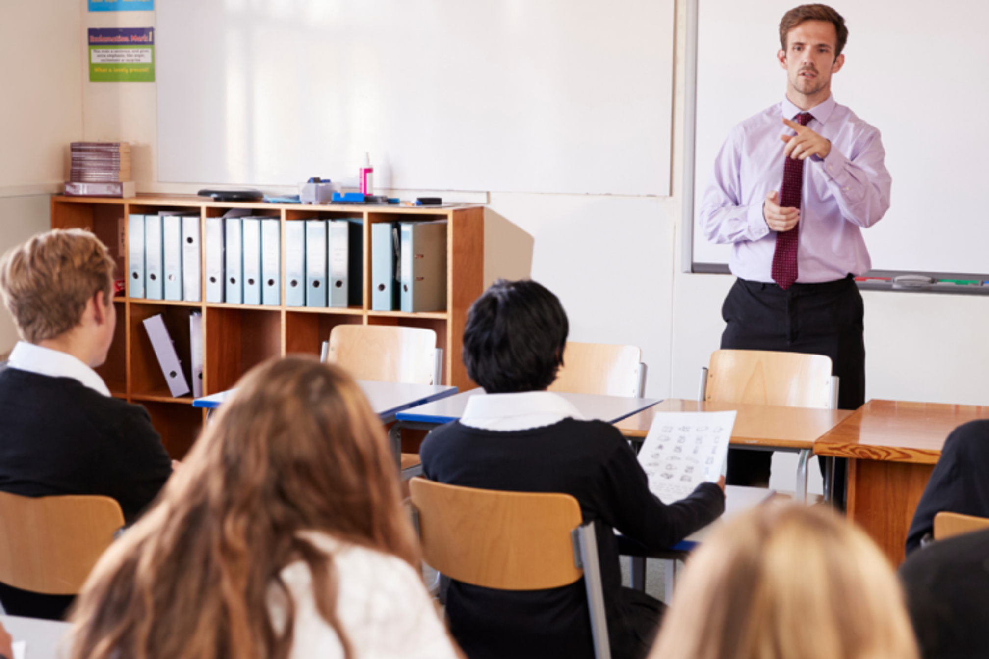 Teacher speaking to a classroom of teenage students