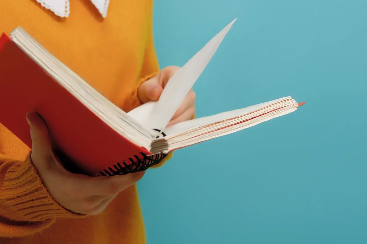 Hands holding an open book