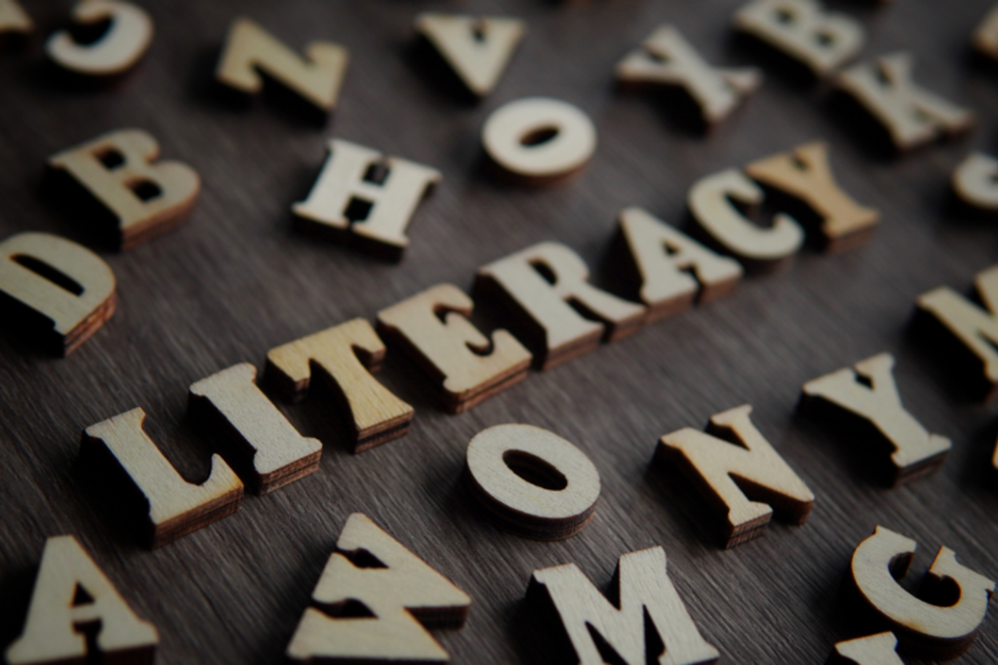Wooden letters on a table spelling "Literacy"
