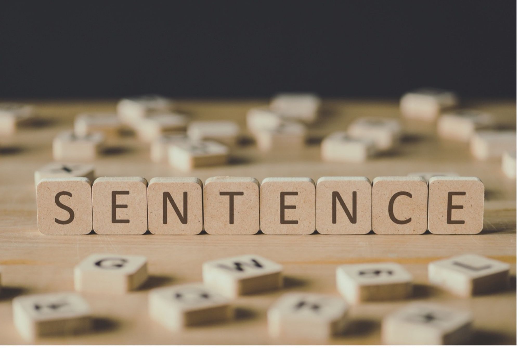 Letter tiles spelling the word "sentence"
