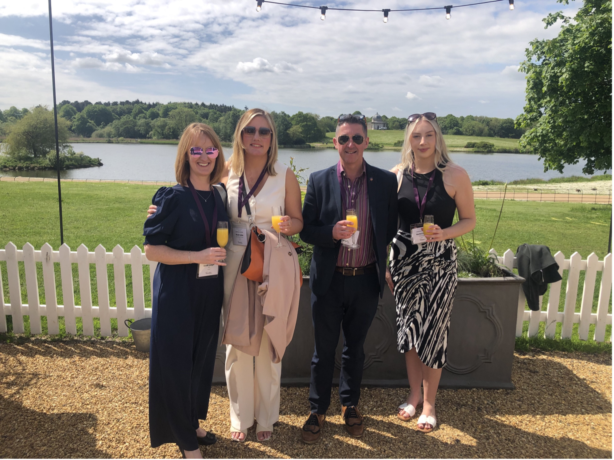 Lexonik CEO and team members at Hardwick Hall in front of the lake at an event posing for photo.
