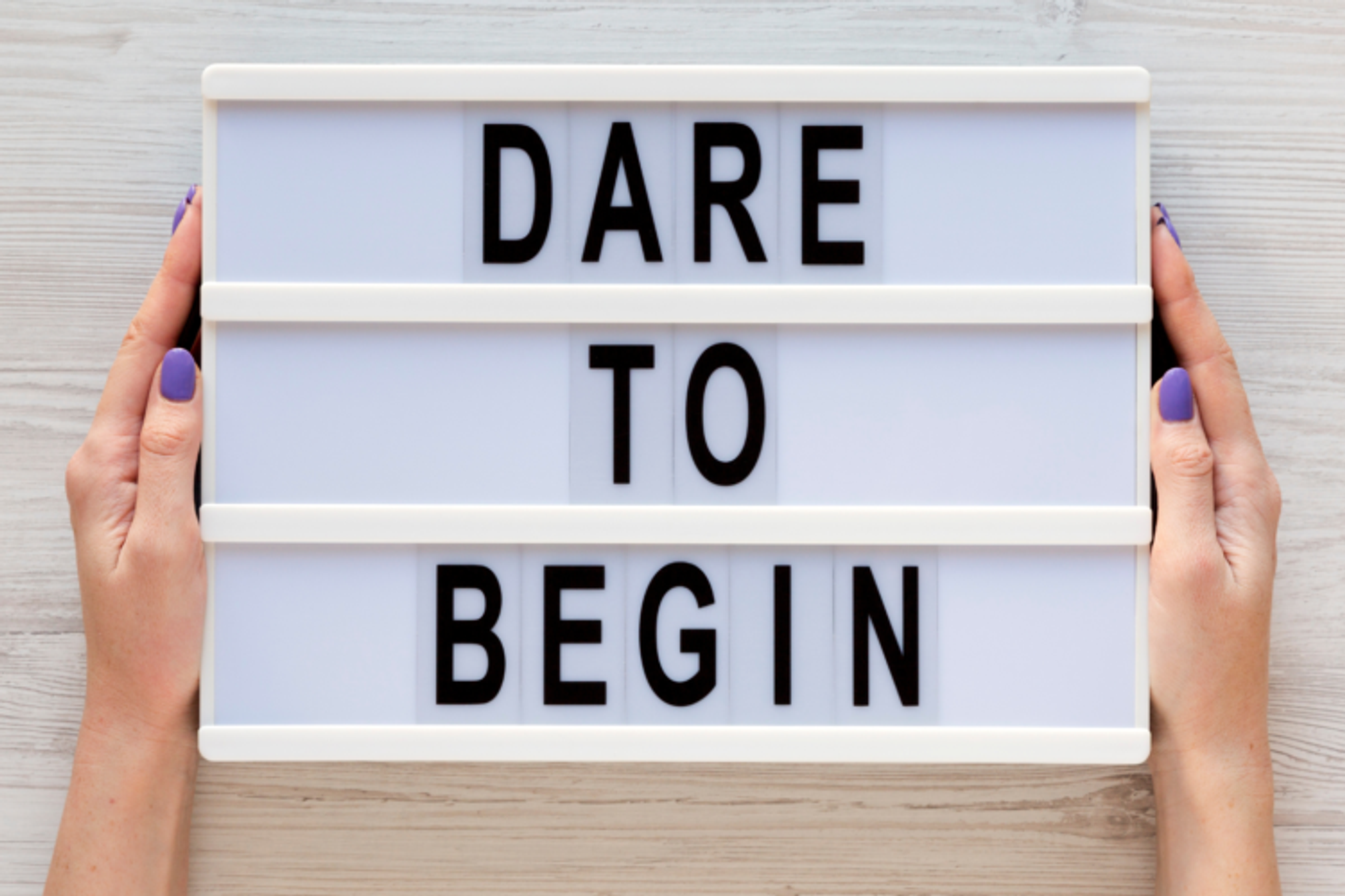 Light box with the words "Dare to Begin".