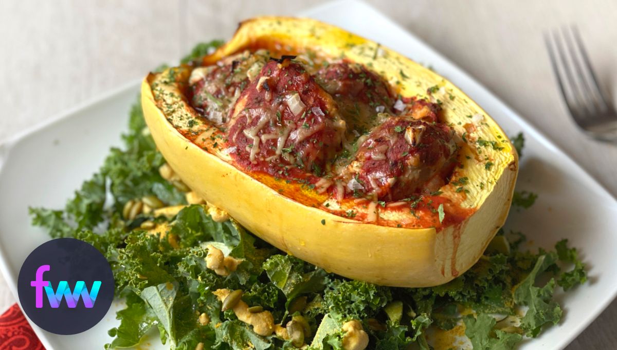 A plate with a spaghetti squash filled with meatballs and marinara.