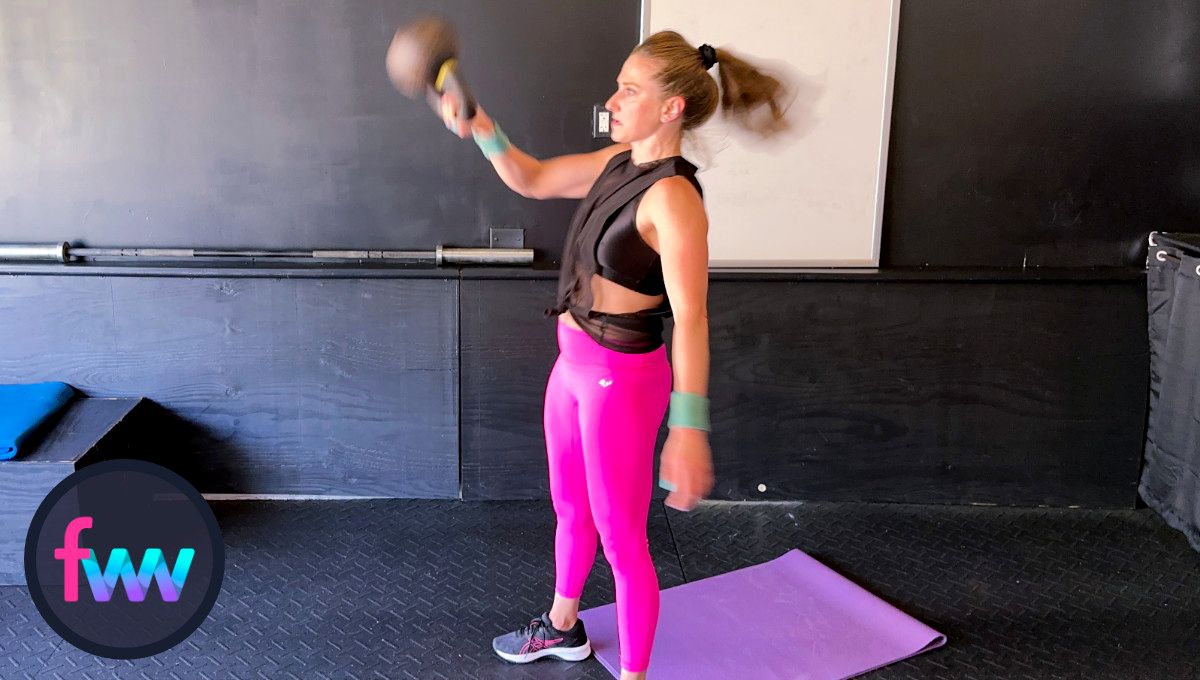 Kindal keeps her elbow close to her body to redirect the kettlebell straight up and ready to punch around the kettlebell.