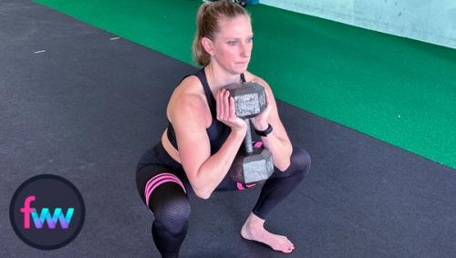 Kindal at the bottom of the goblet squat using the dumbbell vertical grip.