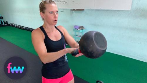 Kindal at the top of a heavy kettlebell swing.