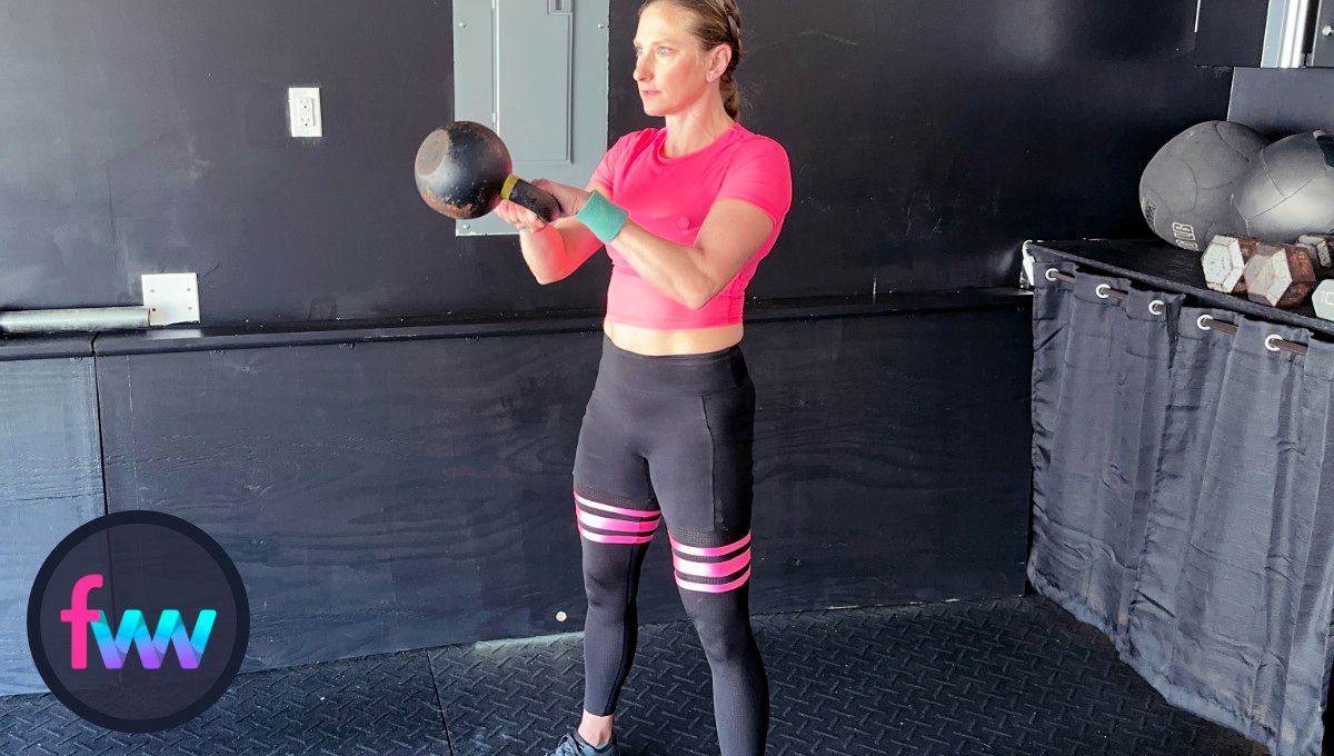 Kindal at the top of the kettlebell swing with a fully locked out body and staying well in balance.