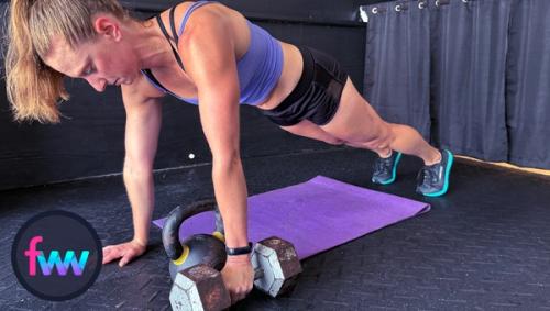 Kindal in the start position for dumbbell renegade rows and you can easily see how her arm fully extends for full range of motion.