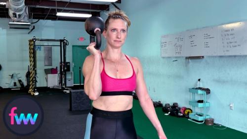 Kindal at the top of the inverted squats. Notice how her arms is perpendicular and she is balancing the kettlebell nicely.