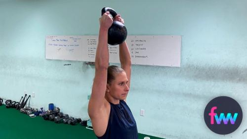 Kindal holding a kettlebell overhead goblet style.