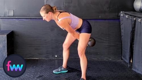 Kindal in the loaded position of the kettlebell snatch and notice her non-weighted arm is swinging back to help with the hip hinge.