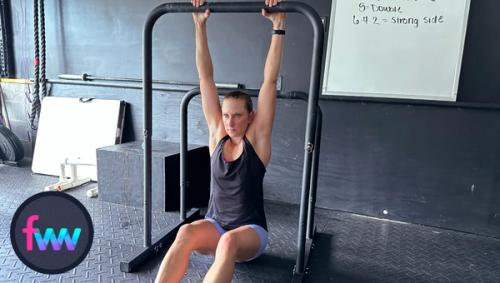 Kindal is dead hanging from her mini-pull up bar. By dead hanging you're stretching out your arms and all the muscles from your forearms through your shoulders. This can help your elbow move better.