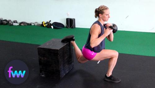 Kindal at the bottom of a racked kettlebell split squat