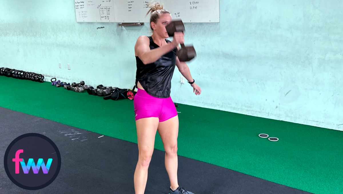 Kindal snatching the dumbbell and notice her elbow is staying closer to her body so she can get the dumbbell up and over her head.