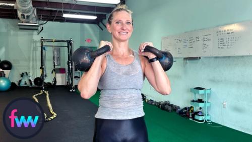 Kindal at the bottom of double presses. In this case she is using kettlebells but you can easily substitute with dumbbells if you need to.