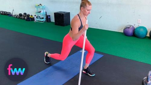 Kindal showing how to use a pvc pike to help you support your prisoner squat.