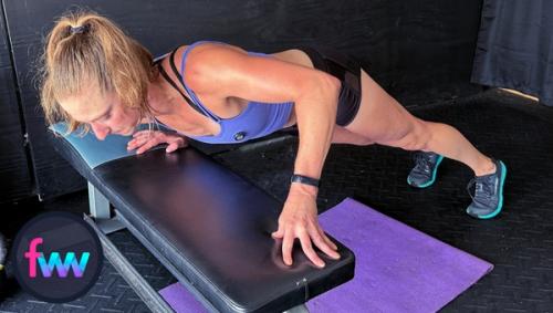 Kindal at the bottom of bench concentration pushups. Notice how she keeps her body in line and does not let her hips drop too low.