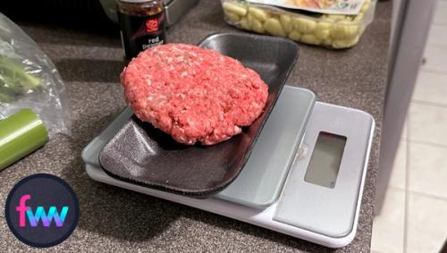 Kindal is measuring some ground beef raw before she cooks it to know the actual grams so she can calculate accurate protein and fat numbers.