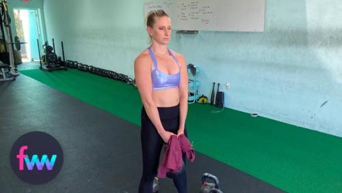 Kindal at the bottom of kettlebell curl with a towel.