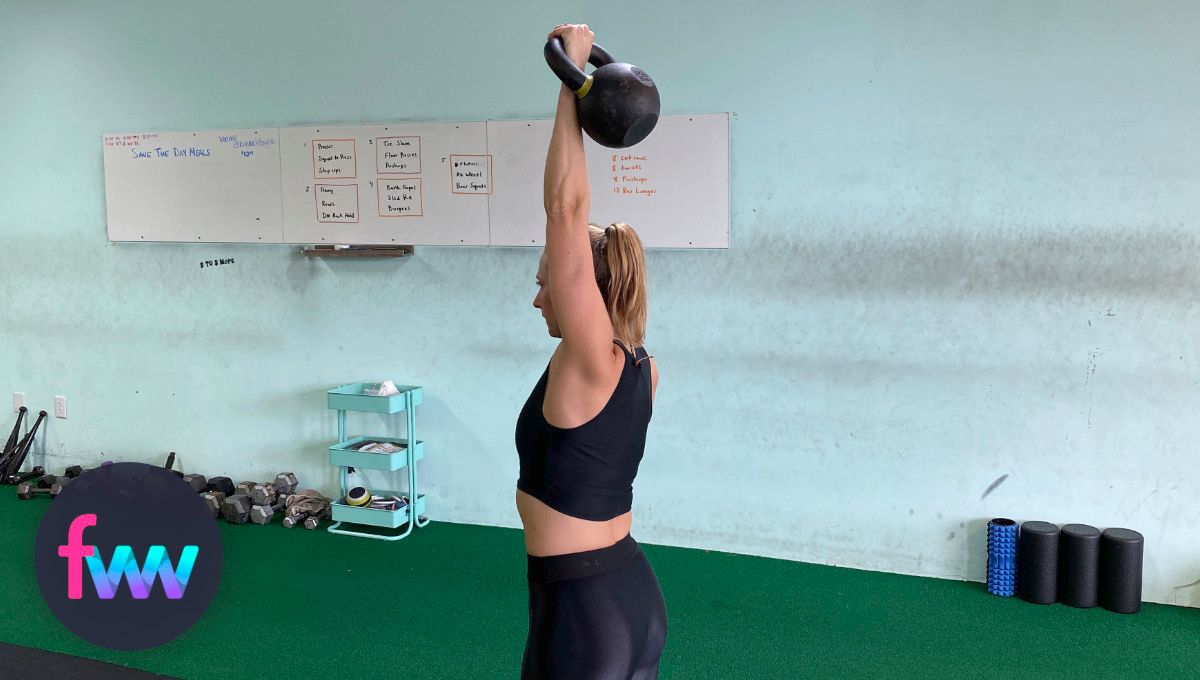 Kindal reaching her kettlebell way over head... fully extended.