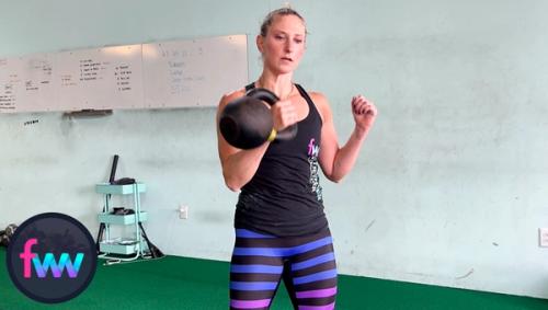 Kindal is punching her hand around the kettlebell ready to accept it in rack position.
