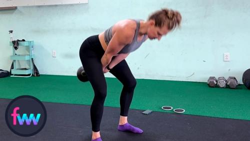 Kindal in the kettlebell swing power position. A strong hip hinge with her hips ready to fire the kettlebell out.