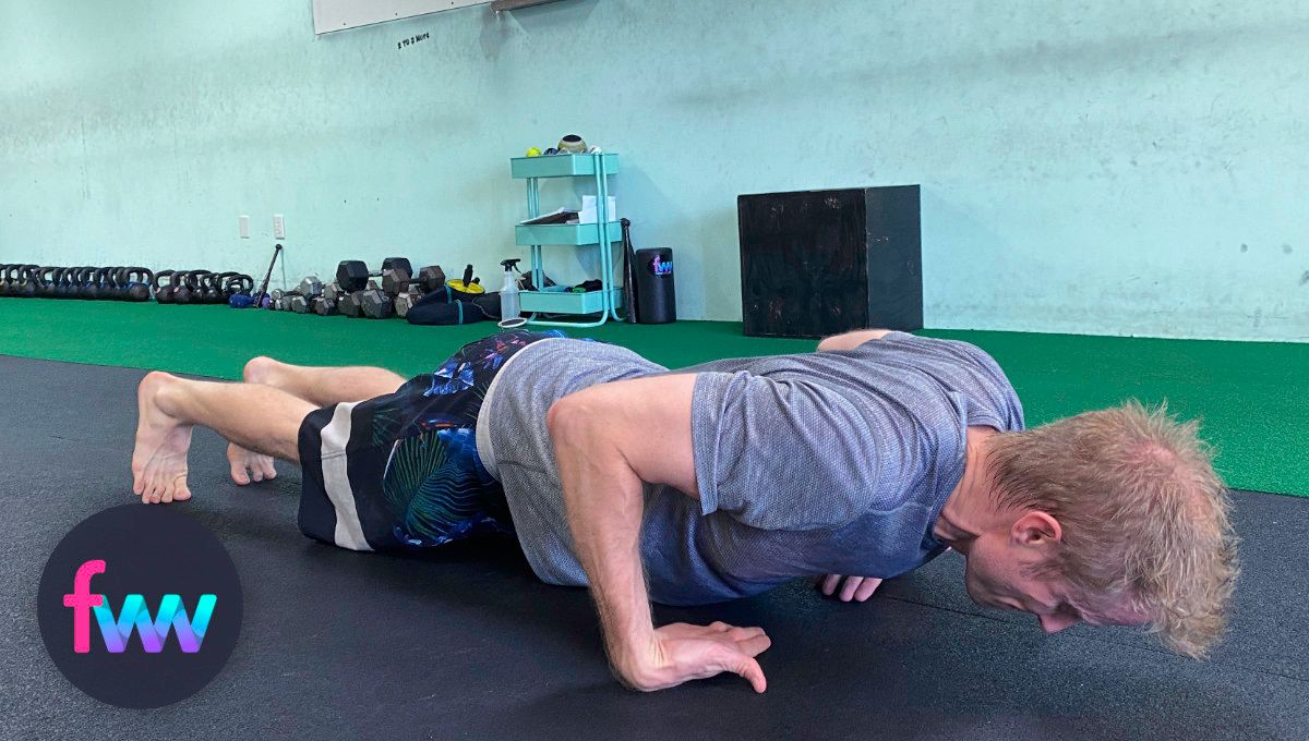 Dan showing the bottom of a top of hands pushup.