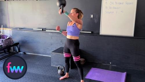 Kindal taking control of the kettlebell and punching around it so it lands softly on her arm with control.