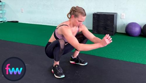 Kindal getting down into a low squat ready to kick her legs out.