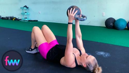 Kindal at the top of the single kettlebell floor press.