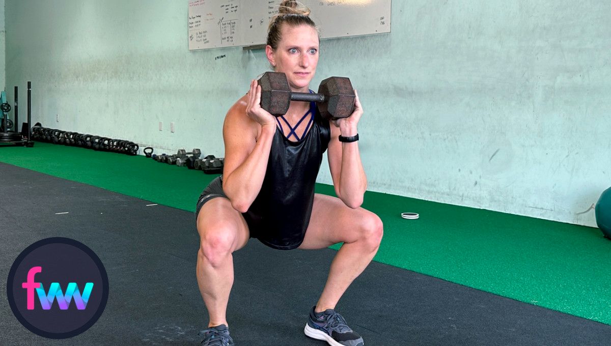 Kindal at the bottom of the dumbbell goblet squat. Notice her knees are pushed out and her torso is really tall and core engaged.