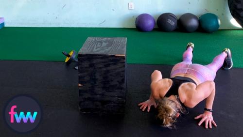 Kindal is getting into a solid pushup getting ready to explode so she can make the jump on top of the box.