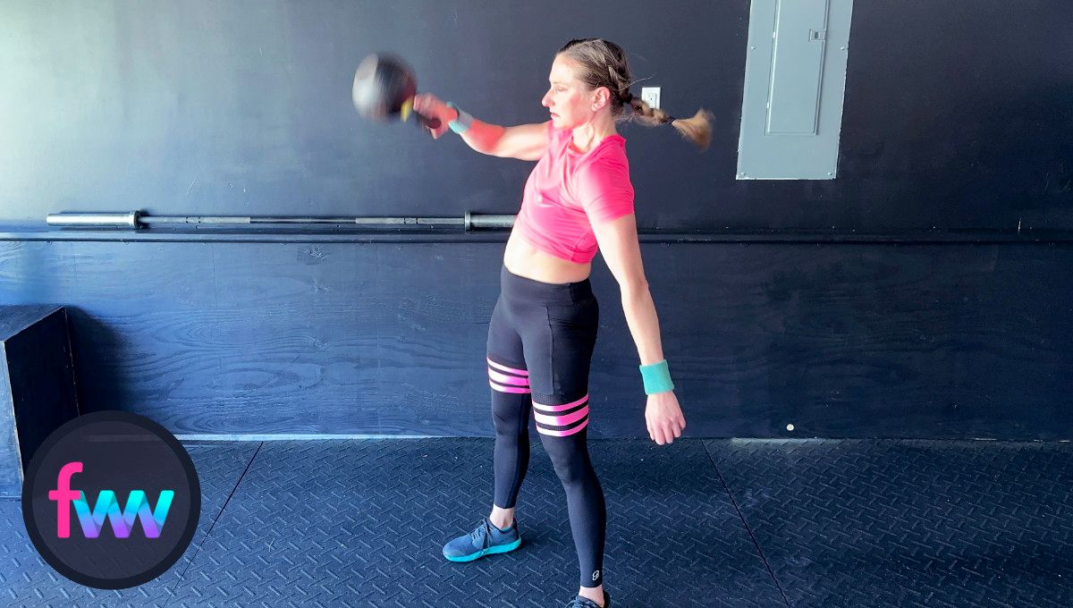 Kindal sets her feet and starts the punch around the kettlebell as it gets to her chest level.