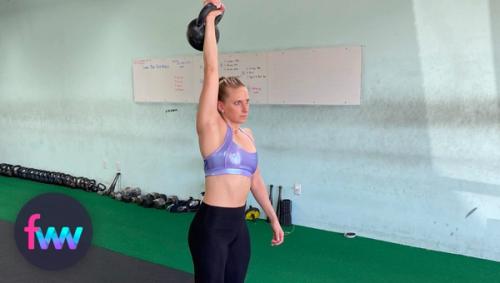 Kindal holding a kettlebell over her head for a long period of time.