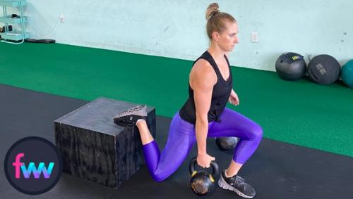 Kindal at the bottom of her kettlebell suitcase Bulgarian split squat.