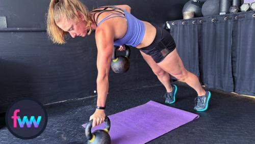 Kindal pulling the kettlebell up for alternating kettlebell renegade rows. You can see how balancing on one kettlebell can be dangerous if you lose balance.