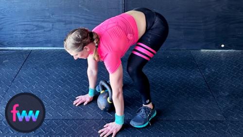 Kindal jumps back into the half burpee tuck working on placing her feet so she can start the floor snatch.