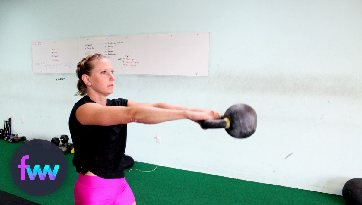 Kindal swinging a kettlebell with unpacked shoulders.