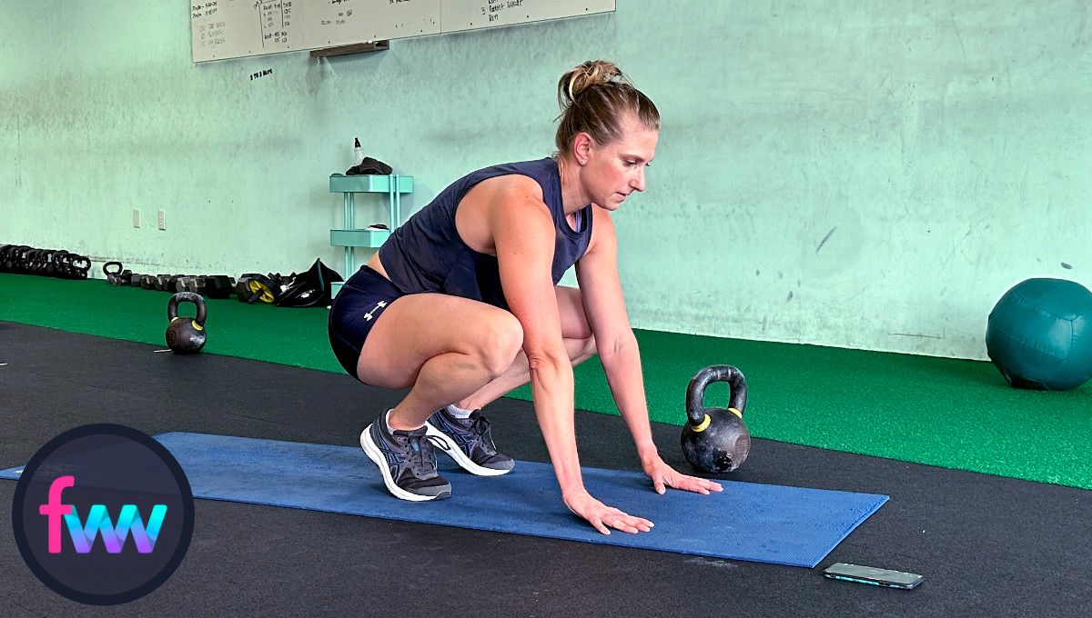 Kindal completed her pushup and now jumps back into the tucked position so she can finish off her burpee.