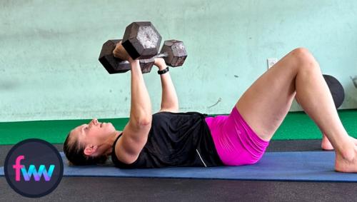 Kindal is continuing to lower the dumbbells really slow. Notice how her muscles are popping which shows that she is squeezing the dumbbells hard. Fully engaged.