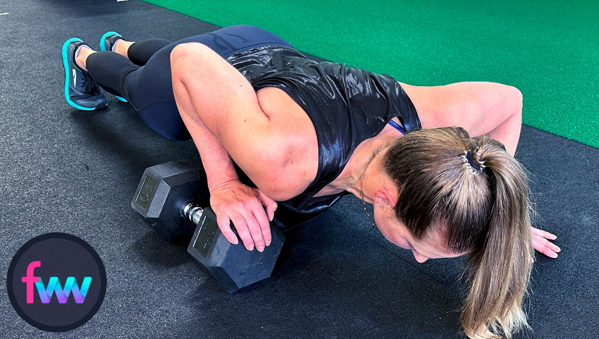 Kindal at the bottom of the dumbbell lizard pushups. You can see how her hand gets much closer to your elbow. That is the increased range of motion.