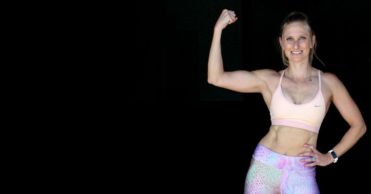 Who is Kindal Kindal flexing and smiling showing her muscles and strength