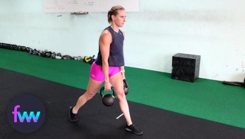 Kindal at the top of double kettlebell suitcase lunge.