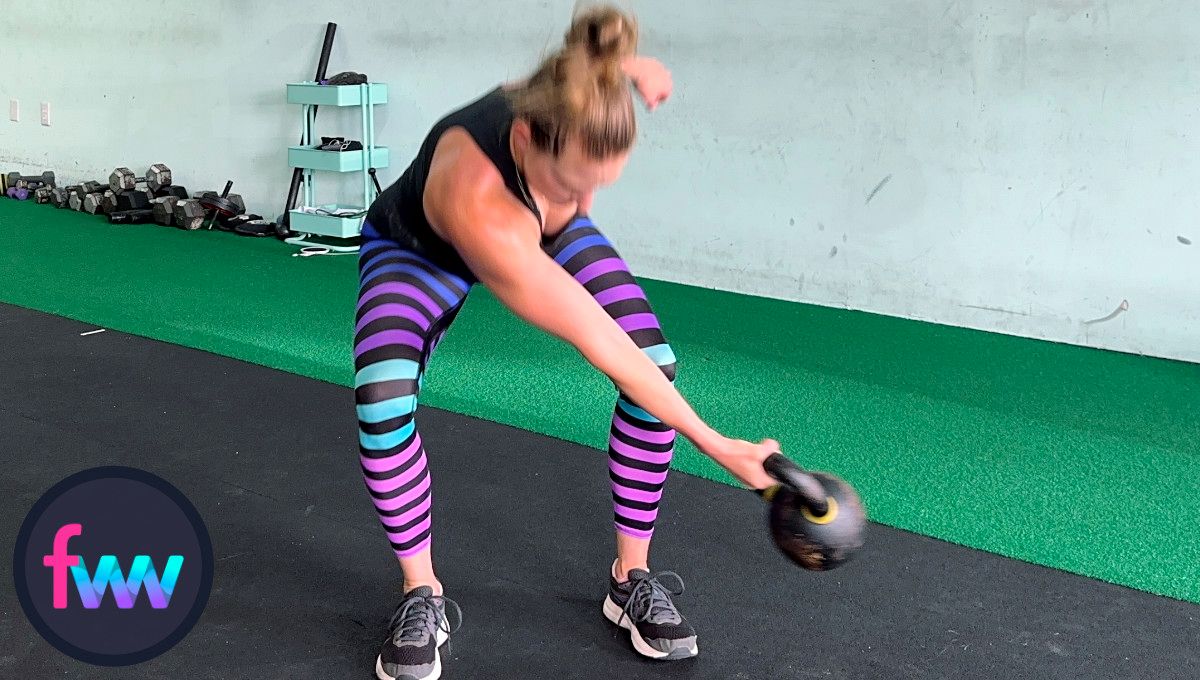 Kindal is in the loaded position of the lateral kettlebell swing. Notice she is squatting down but with a nice hip hinge as well.