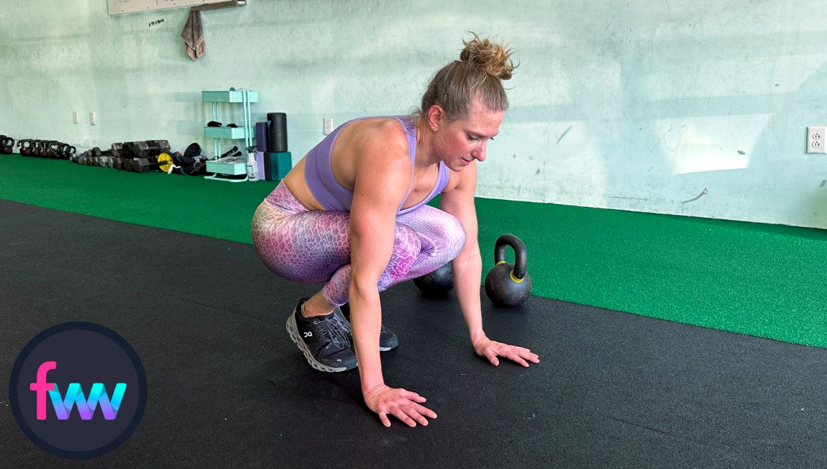 Kindal finished her pushup and is back into tuck position ready to explode out of the burpee.