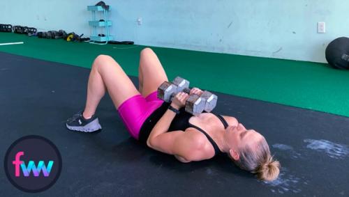 Kindal showing the bottom of the double close dumbbell floor press.