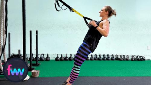 Kindal at the top of the TRX row. She is squeezing her shoulder blades together hard and getting her hands all the way to her chest. Her body remains engaged and tight.