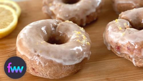 A close up of glazed lemon strawberry donuts