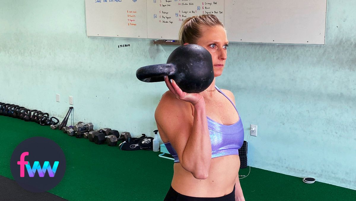 Kindal holding a kettlebell in her palm.