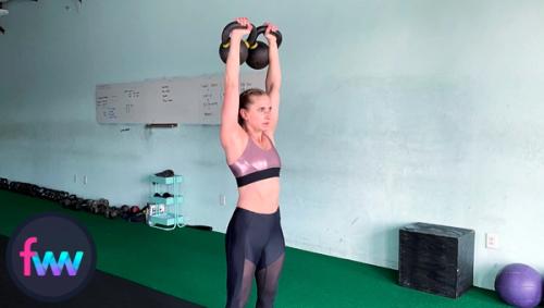 Kindal showing a full extension for double kettlebell presses.